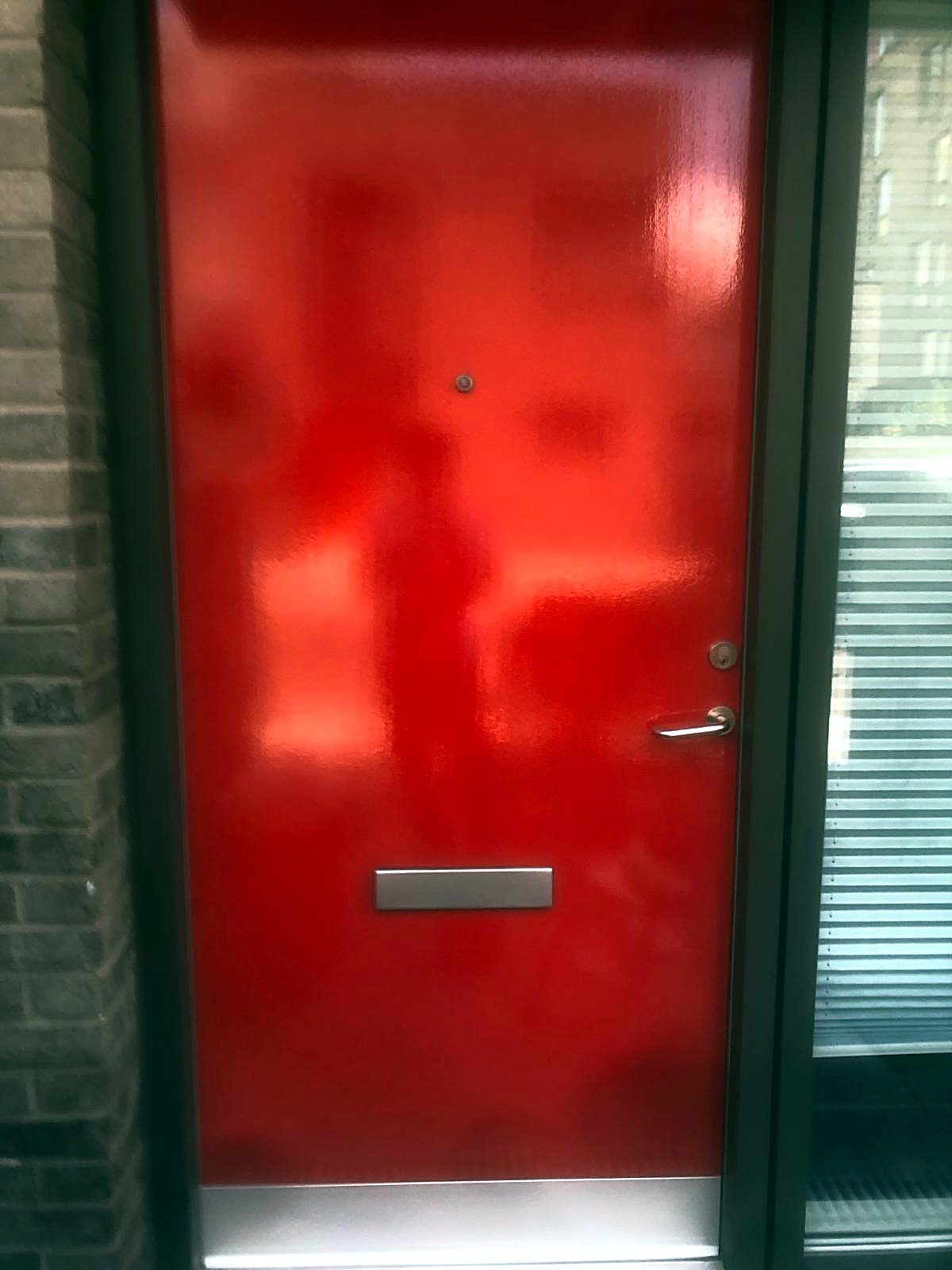 Front door finished in high gloss red